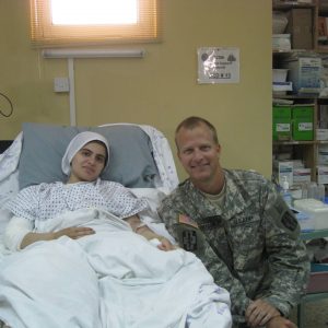 12. Army orthopedic surgeon with injured Iraqi girl (above) recovering three days later at 325th Combat Support Hospital.