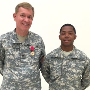 Col. Horvath after being presented the The Legion of Merit medal June 20, 2015. The enlisted soldier is PFC Arius Wright to whom Col. had recently administered the oath of enlistment